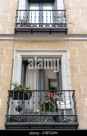 Vue à angle bas sur les balcons traditionnels en fonte de l'ancien Immeuble résidentiel dans le quartier Lavapies dans le centre de Madrid Banque D'Images