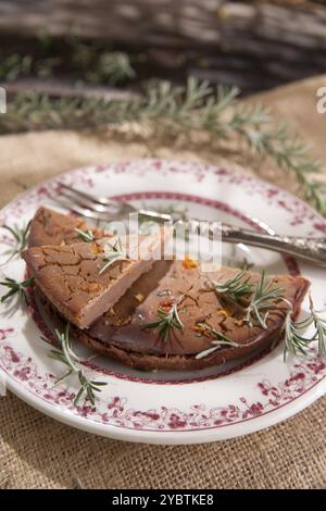 Présentation d'un gâteau de farine de châtaignier avec des branches de romarin Banque D'Images