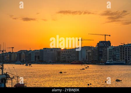 Coucher de soleil coloré sur le port de Marsamxett et le front de mer de Sliema à la Valette, Malte Banque D'Images