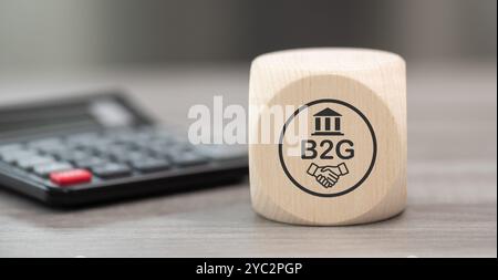 Bloc en bois avec symbole du concept b2g et calculatrice sur fond Banque D'Images