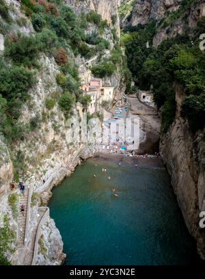 Nichée entre d'imposantes falaises, une plage tranquille invite les visiteurs à se prélasser au soleil tout en profitant des eaux claires. Fiordo Di Furore, le Furore Be Banque D'Images