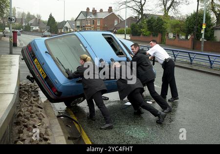 Les policiers des West Midlands poussent une Ford Sierra renversée sur ses roues en 2000 Banque D'Images