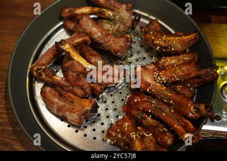 Côtes de porc bouillies assaisonnées et grillées. La viande sur l'os est moelleuse et délicieuse Banque D'Images