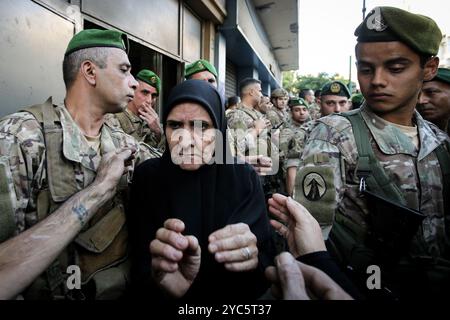 Beyrouth, Liban. 21 octobre 2024. Une libanaise déplacée, qui a fui sa maison dans la banlieue sud de Beyrouth, se fraye un chemin à travers des soldats de l’armée libanaise, alors que les forces de sécurité tentent d’expulser des personnes déplacées d’un vieil hôtel dans le quartier de Hamra, au cœur de Beyrouth. Au moins 1,2 millions de personnes ont fui les hostilités en cours entre Israël et le Hezbollah pro-iranien. Crédit : Marwan Naamani/dpa/Alamy Live News Banque D'Images