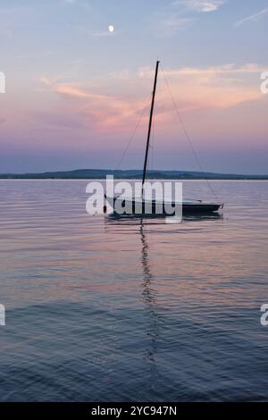 Petit voilier amarré sous la lune sur le lac Balaton, Revfulop, Hongrie, Europe Banque D'Images