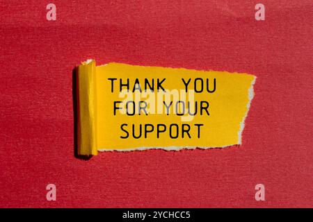 Merci pour votre message de support écrit sur papier déchiré jaune déchiré avec fond rouge. Merci conceptuel pour votre symbole de soutien. Copier l'espace. Banque D'Images