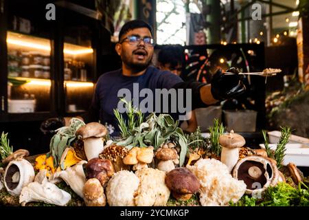 Un homme distribue gratuitement un risotto aux champignons sauvages au Borough Market, Londres, Angleterre, le 23 octobre 2024. Photo : SMP News Banque D'Images