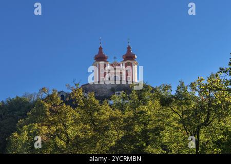 Banska Stiavnica, Slovaquie, 28 septembre 2022 : vue du calvaire rouge Banska Stiavnica sous un ciel bleu avec forêt au premier plan, Europe Banque D'Images