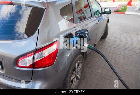 L'essence de pompage du carburant dans les voitures à la station de gaz Banque D'Images
