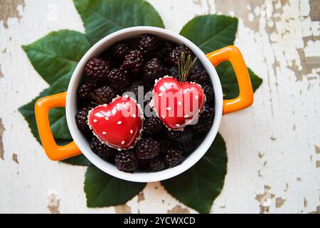 Une totalité de l'assiette avec un dessert en forme de coeur se dresse sur un vieux fond de bois Banque D'Images