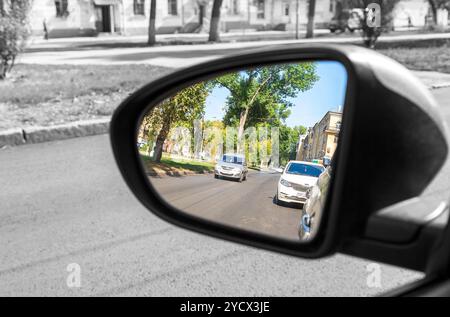 Samara, Russia - September 5, 2017: Reflection in the rearview mirror of a car in summer sunny day Stock Photo