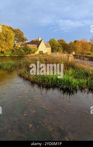 Le dernier de la lumière du soir d'automne sur l'ancien moulin à côté de la rivière Coln dans la ville Cotswold de Fairford, Gloucestershire, Angleterre Royaume-Uni Banque D'Images