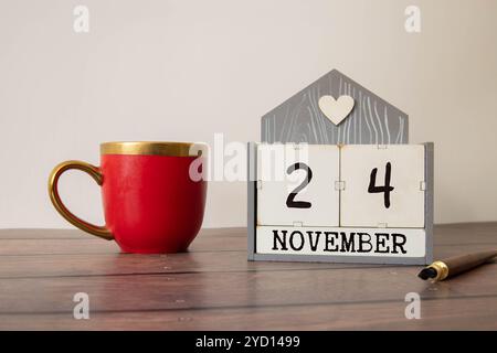 Le 24 novembre est commémoré en tant que Journée mondiale des jumelles conjointes avec un arrière-plan de calendrier en bois Banque D'Images