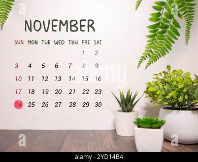 Le 24 novembre est commémoré en tant que Journée mondiale des jumelles conjointes avec un arrière-plan de calendrier en bois Banque D'Images