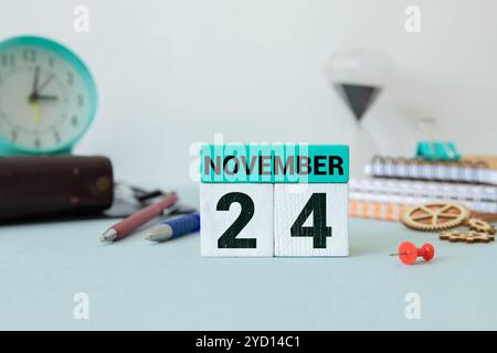 Le 24 novembre est commémoré en tant que Journée mondiale des jumelles conjointes avec un arrière-plan de calendrier en bois Banque D'Images