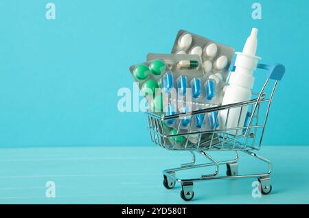 Panier chargé avec des pilules sur fond bleu. La notion de médecine et la vente de médicaments. Copier l'espace. Vue de dessus Banque D'Images