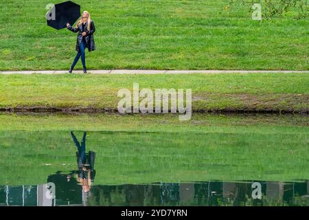 Glimmers in the Gloom : a Woman's graceful Dance with the Rain Banque D'Images