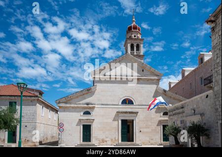 Église de Jérôme de Stridon Beffroi, Pucisca, île de Brac, Croatie 22 mai 2024. De nombreux bâtiments sont construits en pierre blanche Banque D'Images