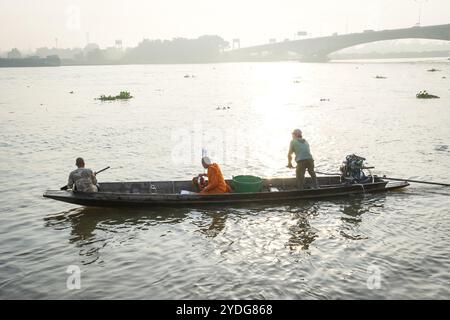 Thaïlande. 25 octobre 2024. Un moine est vu assis sur un bateau en bois au lever du soleil avec le fond de la ville, sur la rivière Chao Phraya, au temple Wat Chin Wararam Worawihan, dans la province de Pathum Thani, en Thaïlande. La tradition de donner l'aumône à une centaine de moines à Pathum Thani, en Thaïlande, est une cérémonie bouddhiste vieille de plusieurs siècles qui se tient le long des rivières et des canaux après la fin du Carême bouddhiste. Les moines se rassemblent dans des bateaux pour recevoir des offrandes des habitants, qui préparent la nourriture et participent à la création de mérite. Cet événement célèbre la communauté, la foi et le patrimoine culturel. Crédit : SOPA images Limited/Alamy Live News Banque D'Images