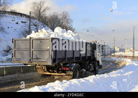 Helsinki, Finlande, le 31 janvier 2019 : un camion à benne basculante emporte la neige déneigée des rues vers un site de déneigement urbain, en Europe Banque D'Images