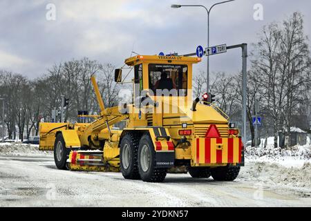 Niveleuse jaune Veekmas FG 2327 S enlevant la neige de la rue en ville après les chutes de neige hivernales. Salo, Finlande. 22 janvier 2021 Banque D'Images