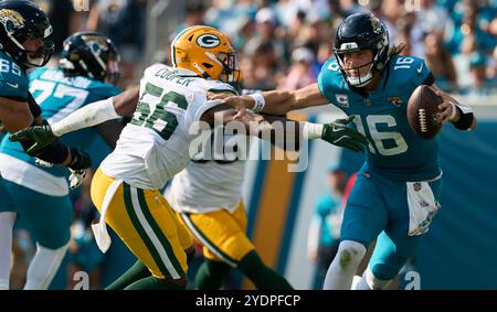 Jacksonville, Floride, États-Unis. 27 octobre 2024. National Football League, Jacksonville Jaguars vs Green Bay Packers. Le quarterback des Jaguars de Jacksonville, Trevor Lawrence (16 ans), tente d'échapper à l'emprise du linebacker Edgerrin Cooper (56 ans) des Packers de Green Bay. Crédit photo : Tim Davis/Alamy Live News Banque D'Images