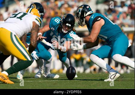 Jacksonville, Floride, États-Unis. 27 octobre 2024. National Football League, Jacksonville Jaguars vs Green Bay Packers. Le quarterback des Jaguars de Jacksonville, Trevor Lawrence (16 ans), plonge après un coup de fouet sur une conduite critique au 4e quart-temps. Lawrence a réussi à battre le joueur de ligne défensif Preston Smith (91) au ballon pour garder leur entraînement en vie. Crédit photo : Tim Davis/Alamy Live News Banque D'Images