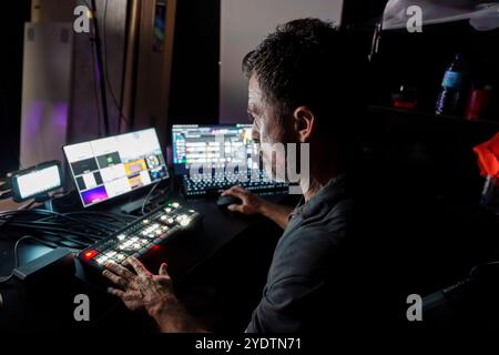 Directeur TV masculin expérimenté panneau de commande d'exploitation dans Studio pendant la production en streaming en direct Banque D'Images