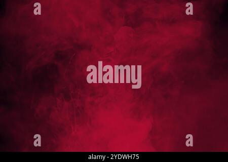Fumée rouge abstraite sur fond noir. Nuages de fumée rouge spectaculaires. Mouvement de fumée colorée Banque D'Images
