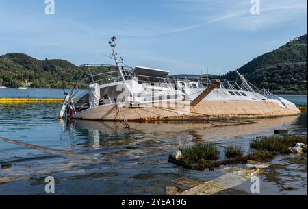 Un bateau à moitié submergé coulé en eau peu profonde. Banque D'Images