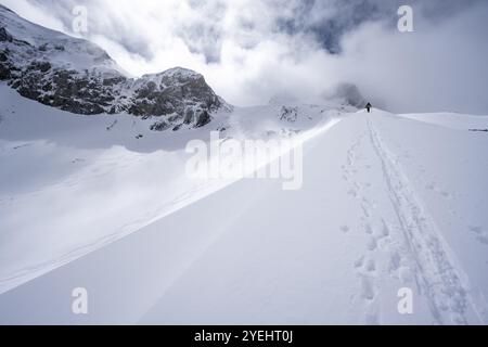 Randonneurs de ski dans un paysage de montagne enneigé, ascension vers le Wildhorn, ambiance nuageuse, haute randonnée, Alpes bernoises, Oberland bernois, Suisse, Europe Banque D'Images