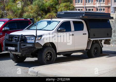 L'image montre un véhicule utilitaire Toyota Hilux 4x4 blanc qui est fortement modifié pour une utilisation hors route et aventure. Banque D'Images