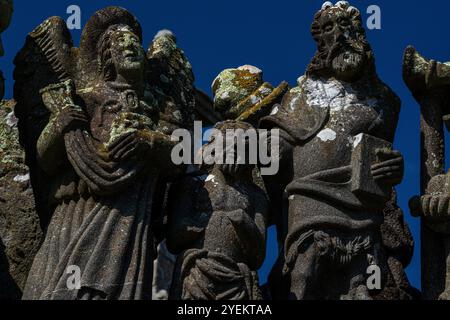 Baptême du Christ avec un ange à gauche et Jean Baptiste à droite. Détail d'une sculpture de la fin des années 1500 sur le niveau supérieur de la face sud du calvaire dans la paroisse près de l'église de Saint Miliau à Guimiliau, Finistère, Bretagne, France. Banque D'Images