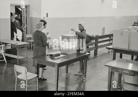 Femme afro-américaine votant à l'école secondaire Cardoza à Washington D.C. photographie montrant une jeune femme afro-américaine lançant son bulletin de vote. ÉTATS-UNIS. 3 novembre 1964 Banque D'Images