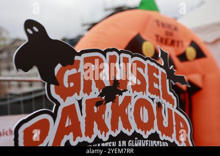 Thale, Allemagne. 31 octobre 2024. Un panneau avec l'inscription 'Grusel Parkour' peut être vu dans le Kurpark Thale. Le festival d'Hexoween se tient ici pendant quatre jours. Une nouvelle fonctionnalité est un cours effrayant qui apprend aux visiteurs à avoir peur. Les autres points forts du week-end incluent un défilé de sorcellerie et un programme de scène coloré. Crédit : Matthias Bein/dpa/ZB/dpa/Alamy Live News Banque D'Images