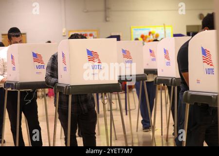 Baltimore, États-Unis. 31 octobre 2024. 31 octobre 2024, Baltimore City, Maryland, États-Unis. De très longues files de personnes attendant de voter la dernière nuit du vote anticipé à l'élection présidentielle de 2024. Tous les électeurs en ligne à 20 heures HNE allaient voter. Certaines personnes portaient des costumes d'Halloween. Beaucoup de gens ont amené leurs enfants à témoigner de cette élection historique où les sondages sont très proches. (Photo de Robyn Stevens Brody/Sipa USA) crédit : Sipa USA/Alamy Live News Banque D'Images