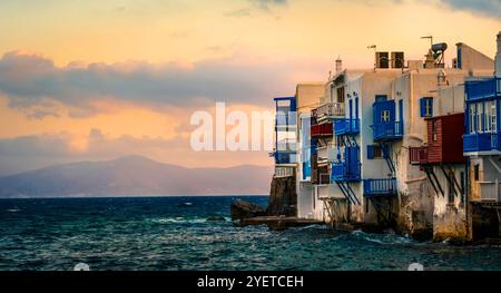 Paysage marin avec des maisons traditionnelles sur la mer sur une île de Mykonos au coucher du soleil, petite Venise grecque Banque D'Images