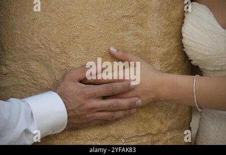 Marié et mariée tenant la main pendant le mariage montrant le dévouement à l'amour Banque D'Images