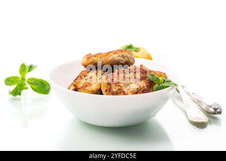 côtelettes de poulet frites dans un bol, isolées sur fond blanc. Banque D'Images