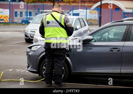 Une voiture électrique reçoit un ticket de parking au Wythenshawe Forum Banque D'Images