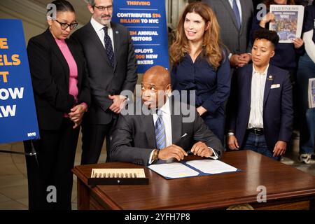 New York, New York, États-Unis. 4 novembre 2024. Le maire de New York Eric Adams (assis) signe le Safe Hotels Act en tant que commissaire du Département de la protection des consommateurs et des travailleurs de la ville de New York Vilda Vera Mayuga (à gauche), Rich Maroko, président du Hotel and Gaming Trades Council (au centre), et Julie Menin, membre du conseil municipal de New York, parrain d'Intro. 0991 (à droite), regardez. (Crédit image : © Mark J. Sullivan/ZUMA Press Wire) USAGE ÉDITORIAL SEULEMENT! Non destiné à UN USAGE commercial ! Crédit : ZUMA Press, Inc/Alamy Live News Banque D'Images