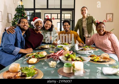 Jeunes amis multiraciaux célébrant noël ensemble, à la maison Banque D'Images