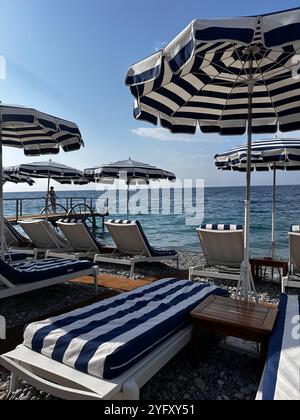 Chaises longues dans un bar de plage à Nice, Sud de la France Banque D'Images