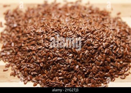 Beaucoup de graines crues brunes de lin faites pour la cuisine. Vue de dessus. Effectuez la mise au point au centre des grains Banque D'Images