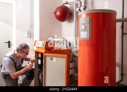 l'installateur vérifie un ancien chauffage au gaz Banque D'Images