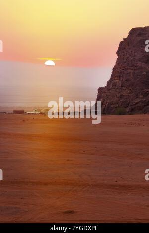 Jordanie, Wadi Rum soleil apparaît au-dessus de l'horizon, lever du soleil dans le désert, tentes de camp, Asie Banque D'Images