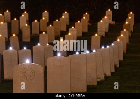 10 novembre 2024. Dimanche du souvenir au cimetière militaire d'Aldershot dans le Hampshire, Angleterre, Royaume-Uni. La cérémonie annuelle de l'éclairage des graves a eu lieu dans la soirée. Toutes les tombes étaient ornées d'une bougie pour rappeler les hommes et les femmes des forces enterrés ici qui ont été tués dans les guerres 1 et 2 et les conflits ultérieurs, et tous ceux qui ont été tués pendant leur service, et un court acte de souvenir a été tenu en leur honneur. Banque D'Images