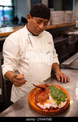 Le chef Andrés Barragán prépare un poisson grillé rouge et vert (Pescado a la talla en espagnol) au restaurant Contramar à Mexico, État de Mexico, Mexique, le jeudi 17 octobre 2024. Le pescado a la talla du chef Gabriela Cámara est un poisson entier au beurre avec une sauce chili rouge d'un côté et une sauce persil vert de l'autre côté. Il a été un succès depuis l'ouverture du restaurant en 1998. Il est devenu l'un des plats les plus reproduits dans les restaurants du monde entier, apparaissant partout de Dallas à Cincinnati en Grèce. (Photo Bénédicte Desrus/Sipa USA) Banque D'Images