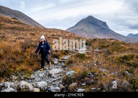 Une femme âgée faisant une randonnée à travers les Hiills/montagnes de Cuillin sur la promenade de Sligachan à Elgol, île de Skye, Écosse, Royaume-Uni. Banque D'Images