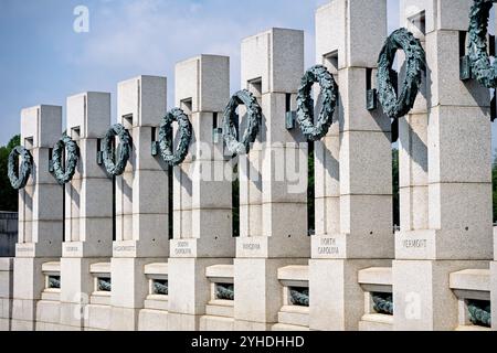 World War II Memorial State Pillars Washington DC // WASHINGTON DC — le National World War II Memorial sur le National Mall comprend 56 piliers de granit ornés de couronnes de bronze, chacun représentant un État américain, un territoire et le District de Columbia qui ont participé à la IIe Guerre mondiale le mémorial, dédié en 2004, entoure la Rainbow Pool restaurée avec son exposition de fontaines élaborées entre le Lincoln Memorial et le Washington Monument. Conçu par l'architecte Friedrich préparé Florian, le monument rend hommage aux 16 millions d'Américains qui ont servi dans les forces armées pendant la guerre, y compris le m Banque D'Images